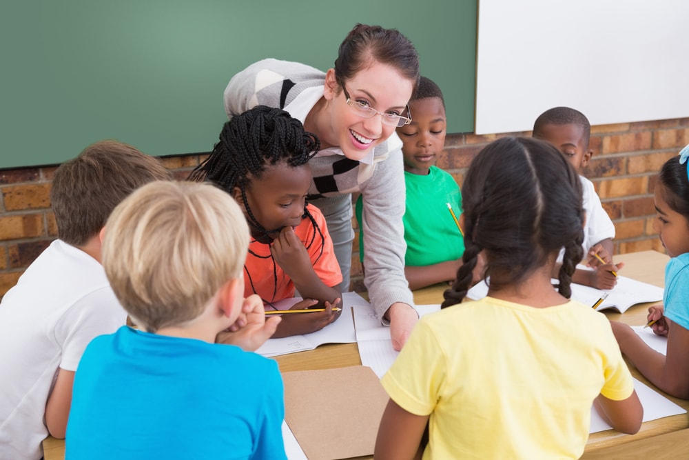 To hold classes. Teachers and pupils working together. Teacher and pupil. Slitted pupils. Over 12 000 children attend the Green Scholls.